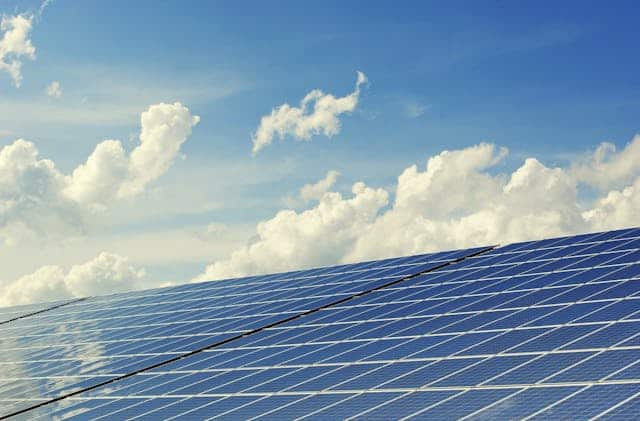solar panels against the cloudy blue sky